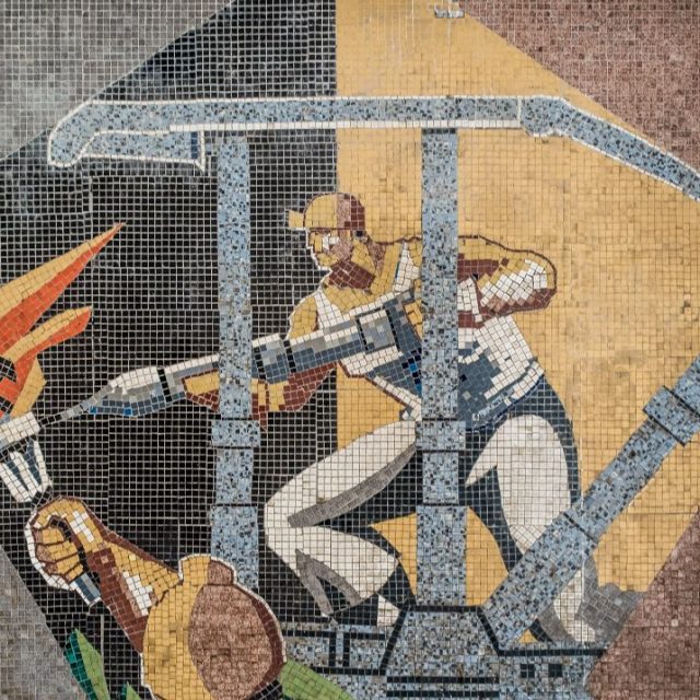 Detail of a large mosaic panel by artist Ladislau Schmidt on the interior wall in administrative building at Petrila Coal Mine.