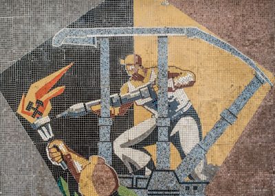 Detail of a large mosaic panel by artist Ladislau Schmidt on the interior wall in administrative building at Petrila Coal Mine.